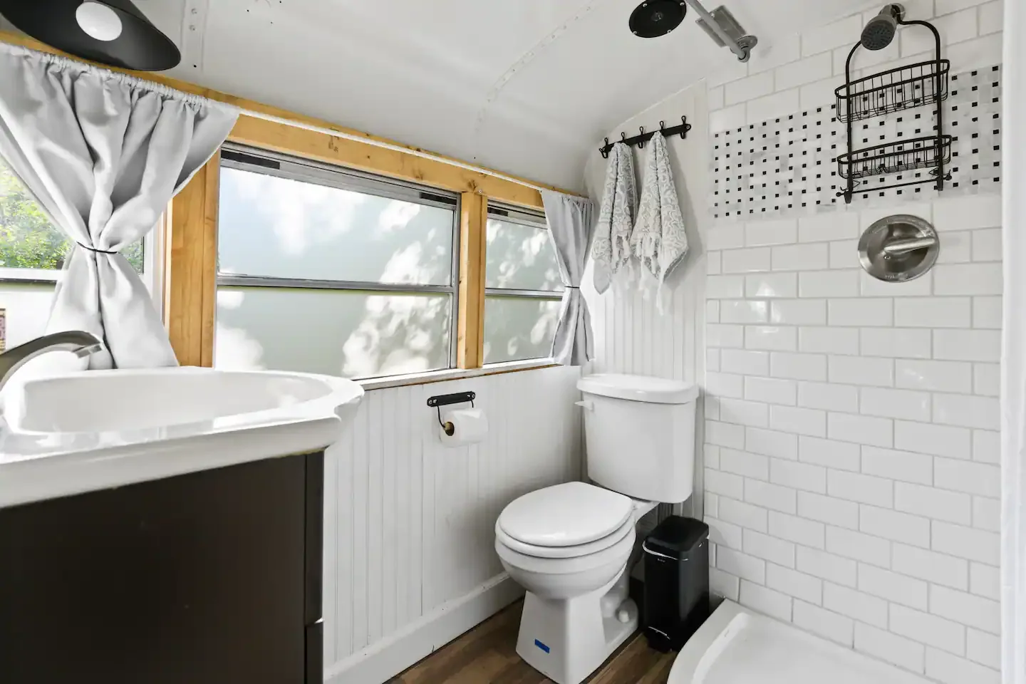 A dedicated bathroom with a tiled shower and vanity.